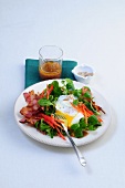 Corn salad with egg and bacon on plate