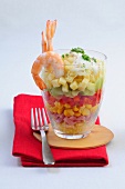 Layer salad with shrimp in glass kept on folded napkin