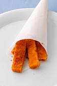 Close-up of fish sticks in paper bag on plate
