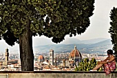 View of woman looking at Florence city from Monte alle Croci, Florence, Italy