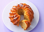 Apple bundt cake with icing sugar on board