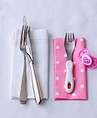 Cutlery on napkin for adults and fork on napkin for kids