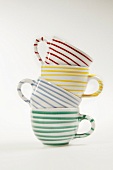 Striped cups in stack on white background