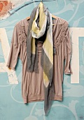 Mauve shirt with patterned scarf on hanger