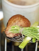 Steamed Pigeon breasts and green asparagus on plate