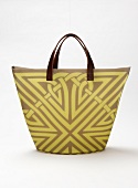 Patterned tote bag with leather handles on white background