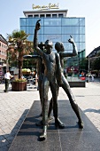 Sculpture with raised little fingers at Klenkes, Aachen, Germany