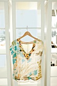 Chiffon top with flower pattern on hanger