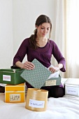 Contemplative woman looking at boxes labelled with different traits