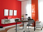 Interior of office in red and white with curtains and picture frames on wall