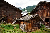 Wooden houses and barns in front of Baroque church