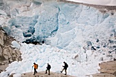 Hikers in front of ice wall in Aletsch Glacier, Marjelesee, Valais, Switzerland