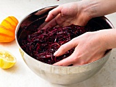 Mixing red cabbage with cranberry in bowl, step 3