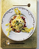 Dandelion salad with acacia flowers dressing on plate