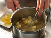 Preparing lemon butter with lemon zest and cubes of butter in sauce pan with whisk, step 2