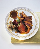 Roast goose with red cabbage on plate