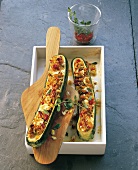 Stuffed zucchini with goat cheese on wooden platter