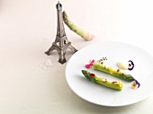 Asparagus with cumin, citrus fruits and almonds on plate