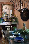 Dining table with fruits in bowl and blue plates