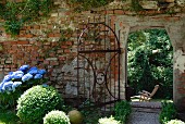 An old garden wall with a wrought iron gate