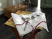Cutlery in white cloth holder
