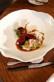 Venison with sauce in bowl from gourmet restaurant