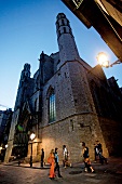 People outside Santa Maria del Mar Church at evening in Barcelona, Spain