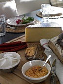 Slices of peasant bread and mountain cheese on table