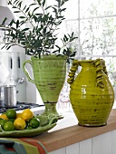 Ceramic vases with green lemons and limes