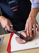 Cutting the veal with knife
