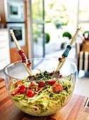 Close-up of zucchini spaghetti in glass bowl on wooden table