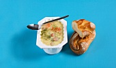 Sausage soup and baguette bread on blue background