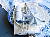 A place setting decorated for Christmas in blue and white