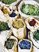Various types of herbs in paper bags