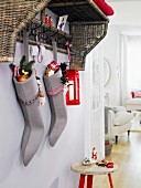 St. Nicholas Day: homemade felt stockings filled with presents hanging from a shelf