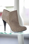 Beige ankle boot with silver rivets on glass platform