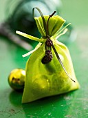 Christmas baubles in a green fabric bag as a gift