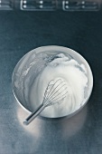 Egg whites beaten with a whisk for preparation of chocolate souffle