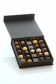 Chocolates in box on white background