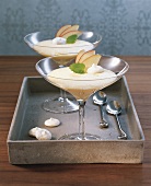 Close-up of apple cream with almond macaroons in dessert glasses