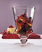 Close-up of rum with fruits, chilli and vanilla in glass