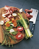 Various ingredients for veal stock on cutting board