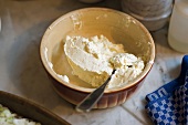 Vowl of cream cheese in bowl with spoon