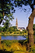 View of Frelser Kirke through river in Christianshavn, Copenhagen, Denmark