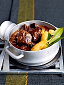 Venison goulash with cherry wine and grappa pears casserole