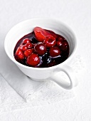 Red fruit jelly with sago and ginger in cup on tissue