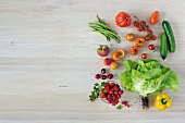 Different types of vegetables on wooden surface, overhead view