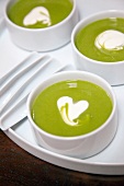 Close-up of cream of pea soup with ginger and artichokes in bowl