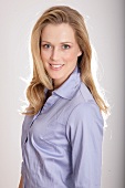 Portrait of beautiful blonde woman wearing shirt, smiling