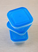 Stack of blue storage boxes on white background
